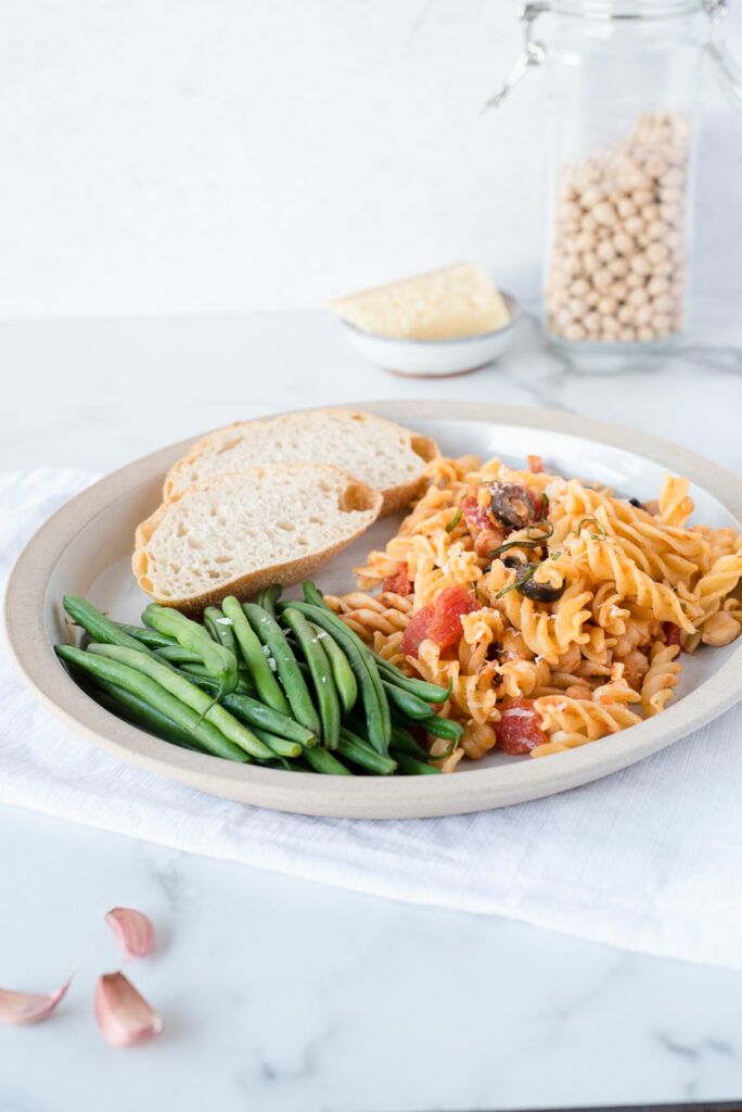 Large plate with pasta, green beans, and sourdough bread