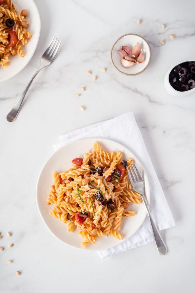 Top down view of plates of fusilli pasta