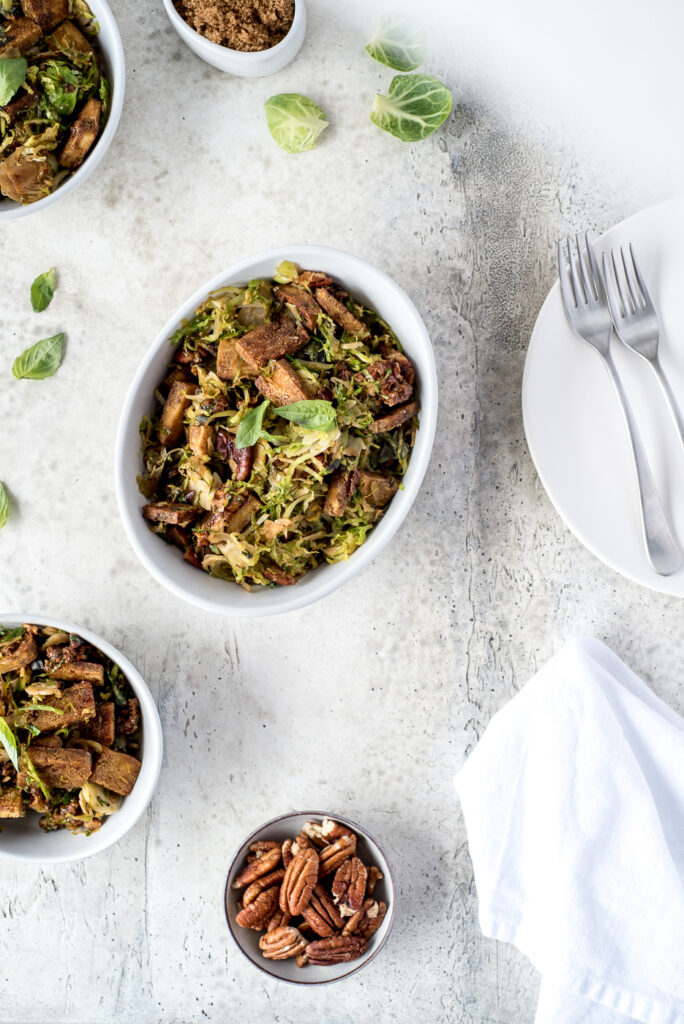 Top down of 3 bowls of brussels sprouts and tofu