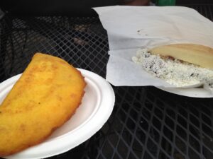 Empanada and Arepa on a paper plate