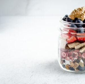 The left half of a mason jar filled with fruit and cereal