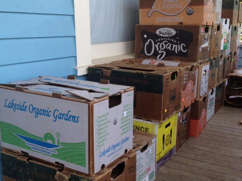 Produce boxes stacked on a porch