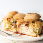 Close up of focaccia on a plate covered in pears and cheese