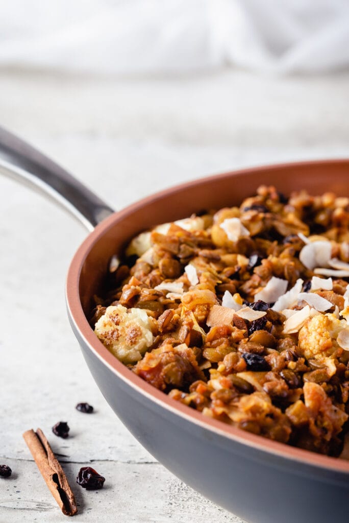 Skillet full of cooked lentils and cauliflower