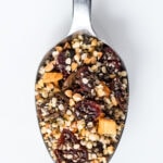 Close up on spoon full of seeds and dried fruit cereal