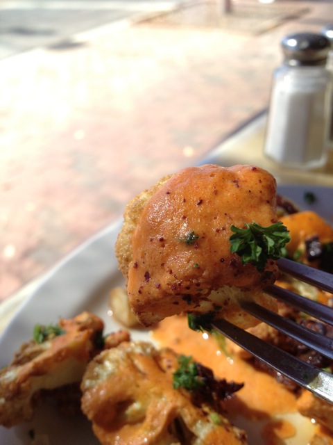 Cauliflower on a fork with tahini sauce