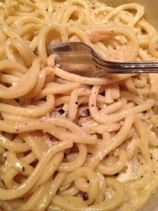 Noodles in a bowl with a cheese and black pepper sauce.