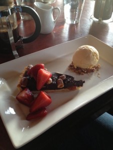 Chocolate tart plated with ice cream