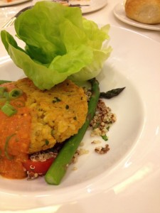 Veggie burger on plate with asparagus and quinoa