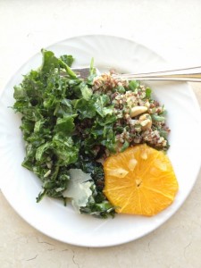 Kale salad, tabbouleh and sliced oranges on a plate