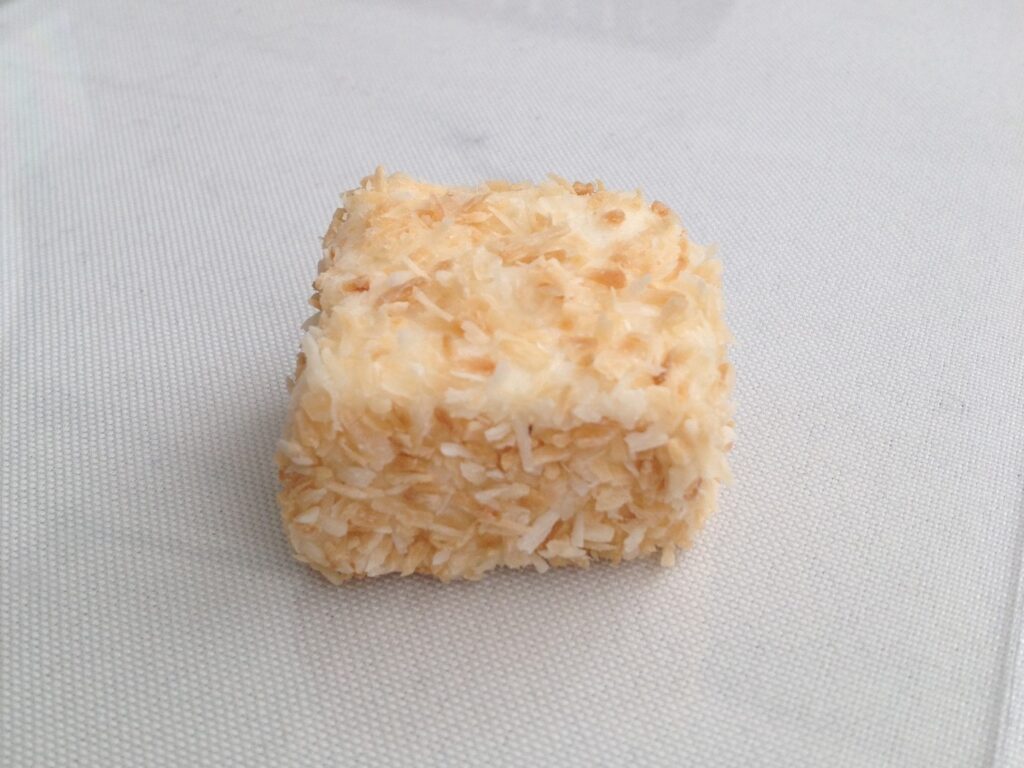 Square marshmallow covered in coconut