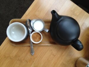 Top down view of a teapot and tea cup in a tea house