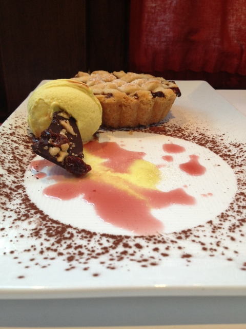 Small cherry pie with ice cream on a plate