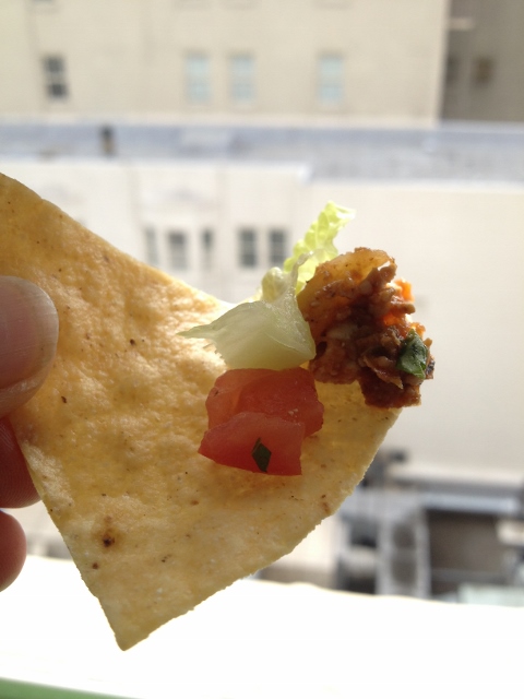 Tofu, tomato and lettuce on a tortilla chip
