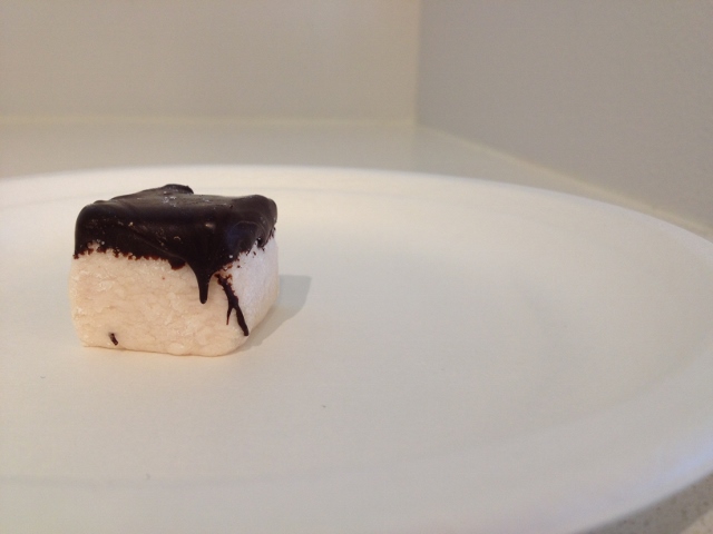 Small marshmallow dipped in chocolate on a plate