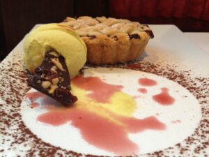 Ice cream and a small pie on a beautifully decorated dessert plate