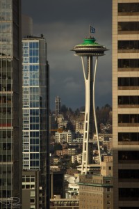 Space needle as seen between buildings