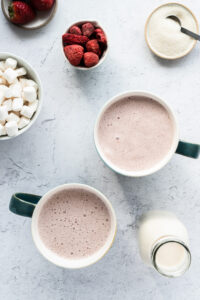 Top down of two mugs of strawberry milk