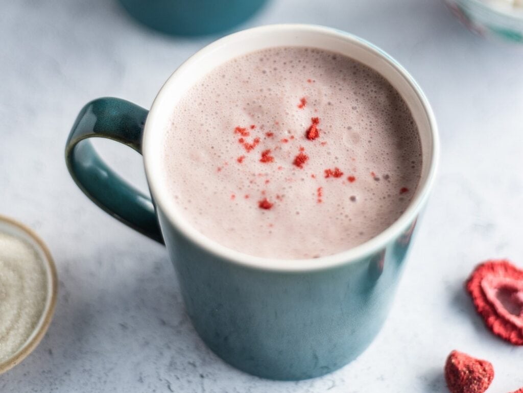 Turquoise cup filled with strawberry milk