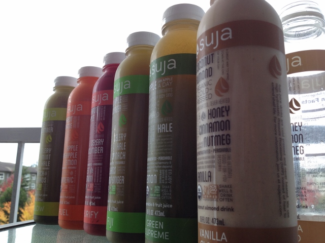 6 bottles of Suja juice lined up side-by-side