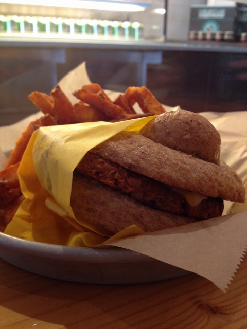 Veggie burger on whole wheat bun with sweet potato fries