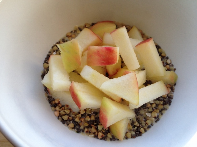 Buckwheat and chia cereal in bowl topped with chopped apples