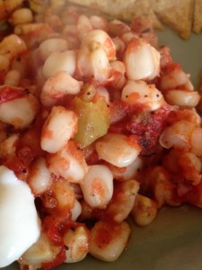 Posole casserole on plate with quesadillas and sour cream