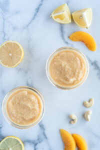 Top down view of two glasses of peach smoothie