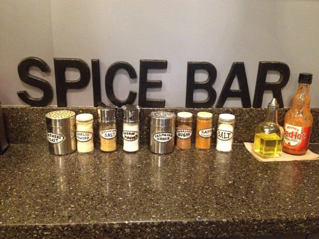 Counter at a movie theater with a selection of popcorn seasonings