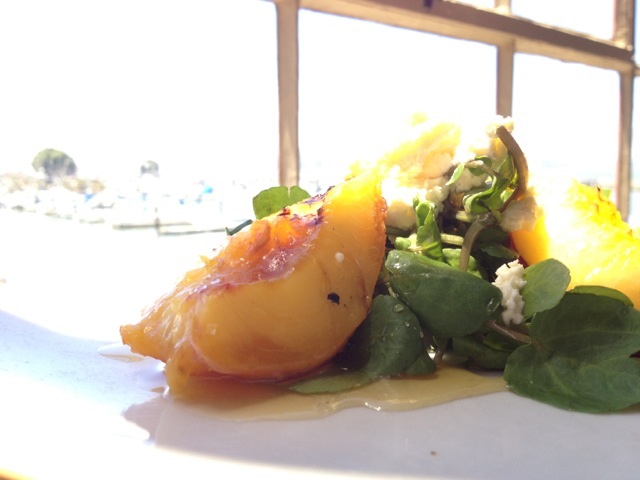 Salad with fresh peaches on a plate