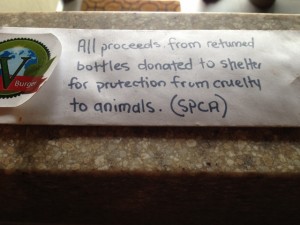 Sign on the recycling container about donating proceeds to protect animals
