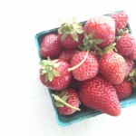 Overhead shot of a pint of strawberries in cardboard basket