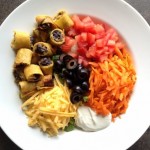 Taquito Salad with olives, carrots, tomato, cheese and sour cream