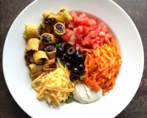 Taquito Salad with olives, carrots, tomato, cheese and sour cream