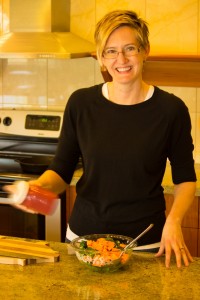 Woman shaking jar of salad dressing