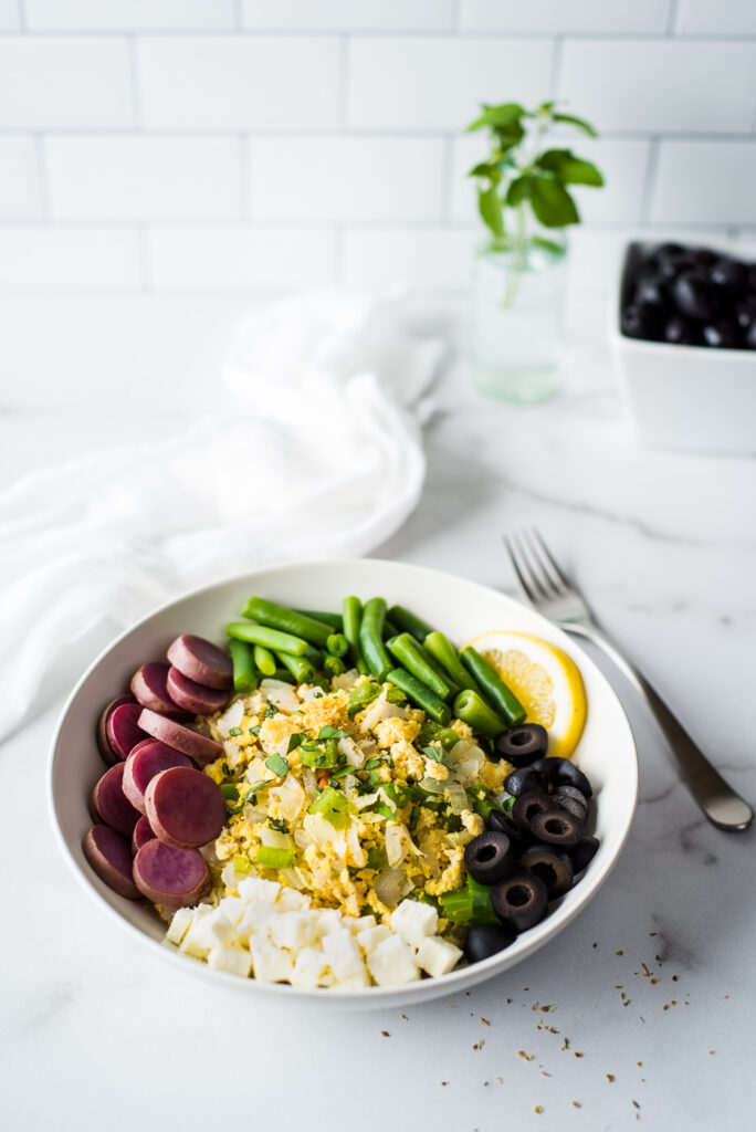 Bowl of tofu and veggies with a fork