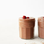 two glasses of chocolate cherry smoothie side by side