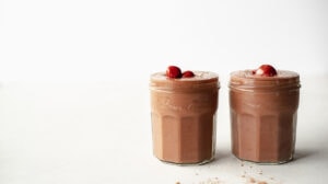 two glasses of chocolate cherry smoothie side by side