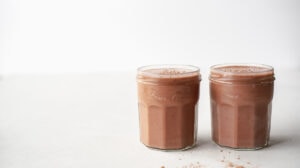 Two small jars of chocolate smoothie side by side