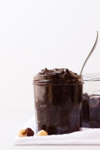 Jar of homemade nutella with a spoon sticking out of it