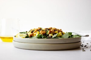 Side view of two stacked plates filled with salad