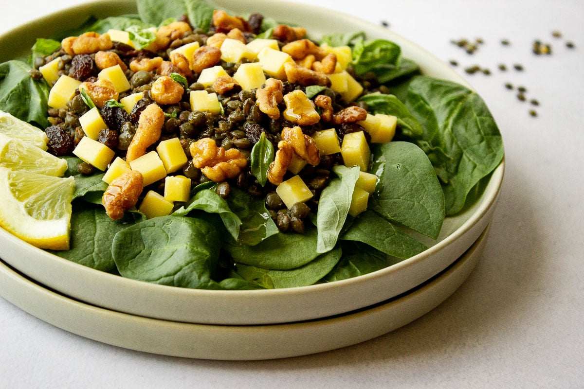 Plate of spinach salad with toppings