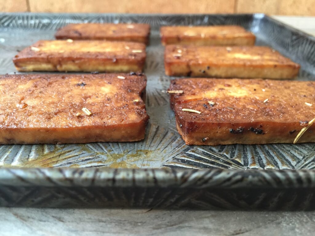 Piece of baked tofu on a cookie sheet