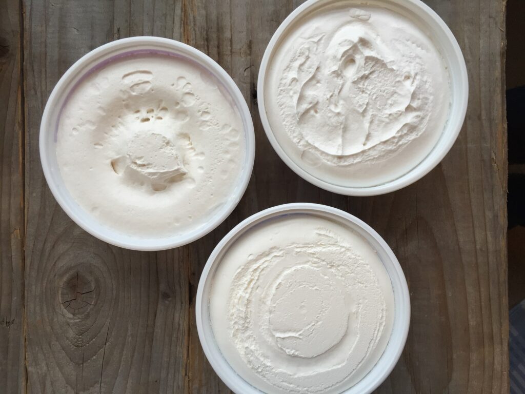 Top down view of 3 tubs of whipped topping