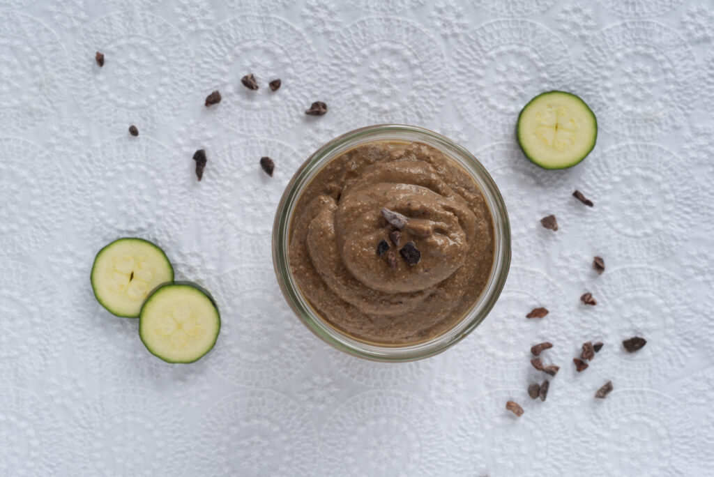 Top down picture of a smoothie in a jar and some zucchini slices