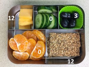Crispbread and cheese bento with fruit and veggies and fat grams
