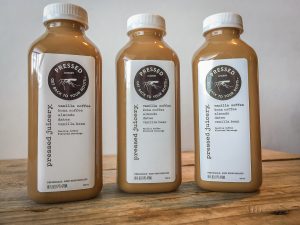 Three bottles of Pressed Juicery Vanilla Coffee