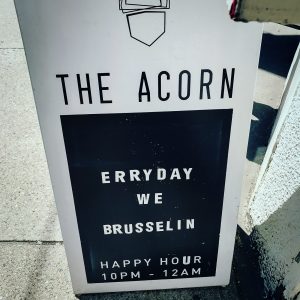 Sandwich board sign for the Acorn Restaurant on the sidewalk
