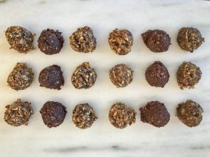 18 balls of nutrition bar dough on a marble slab