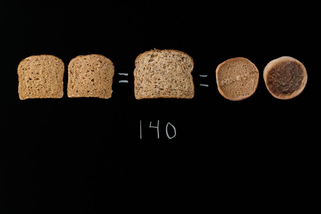 3 slices of bread and one English muffin on black background with 140 written below them